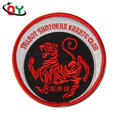 China 3D Design Your Own Logo Cheap Price Fashion Hand Embroidered Badge Iron On Metal Logo Patches For Clothes for sale