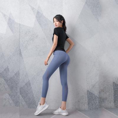 China Breathable Wholesale Yoga Wear Mesh Gym Yoga Jumpsuit Butt Lift Leggings Women Yoga Pants With Pockets for sale