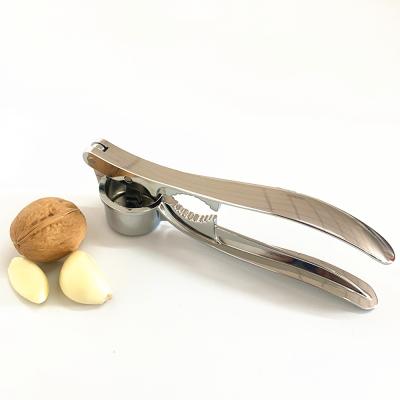 China Viable Kitchen Accessories 2 in 1 Intelligent Fresh Garlic Crusher Nutcracker Instrument Zinc Alloy Garlic Press for sale