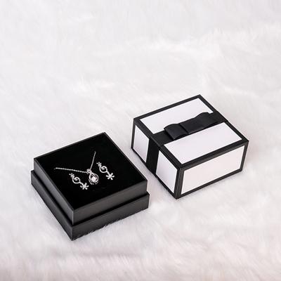 China Luxury Black Jewelry Packaging Paper Materials Recycled Cardboard Boxes With Bow Velvet Foam Inserts For Necklaces Earring Pendant Rings for sale