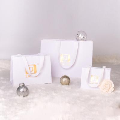 China Recycled materials customized sustainable green red rose gold white mini jewelry packaging luxury paper bag for jewelry cloth for sale