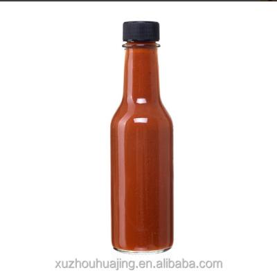 China Hot Sauce 5 Ounce Empty Clear Glass Hot Sauce Bottles With Black Caps And Drip Dispensing Tops for sale