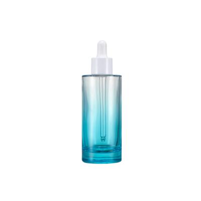 China Fashionable Gradient 100ML Blue Flat Cylinder Shoulder Glass Dropper Bottle for sale