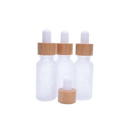 China Eco-Friendly Empty 0.5oz 0.7oz 15ml 20ml Lotion Clear Frosted Essential Oil Serum Glass Bottle With Bamboo Dropper Cap for sale