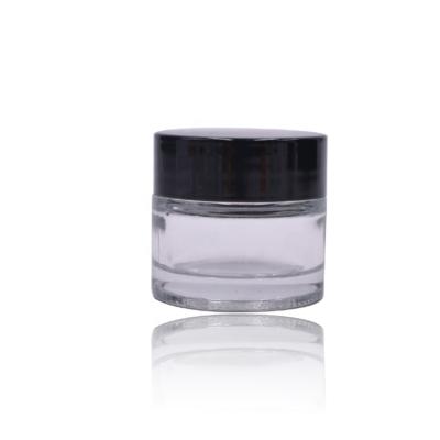 China Classic Wholesale Cosmetic Package Glass Black Plastic Lid Cylinder 5ml Empty Clear Glass Jar With Lid for sale