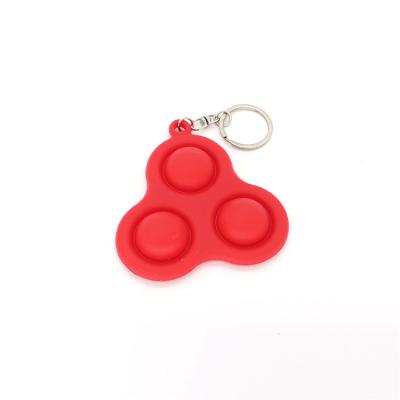 China Relieve stress dimple key chain education riddle early jumping person toys mini simple fidgety toy trigger hand toys for sale