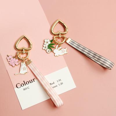 China Lovely Sakura Cat Rabbit Pendant With Hand Lovely Sakura Cat Rabbit Pendant With Hand Lovely Girl Enamel Style First Heart Key Ring Strap Animal Soft Purse Charm for sale