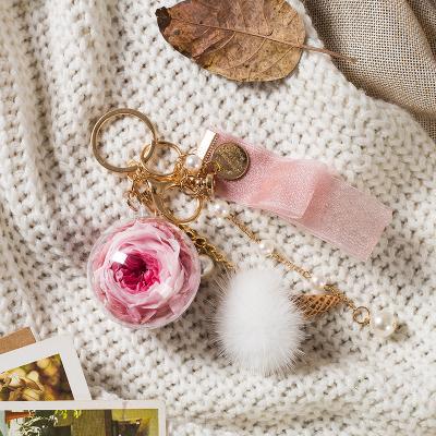 China Preserved rose 5cm acrylic ball rose key chain with hair balls and pearl /preserved rose car hanger key chain for sale