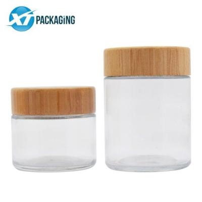 China Top Round 4oz Wooden Airtight Child Proof Cosmetic Clear Glass Jar Customized Logo Screw Cap Wooden Package for sale