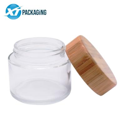 China Sustainable Stocked Clear Glass Jars 3.5g 1/8th Glass Jar Child Proof Branded Flower Packaging Glass Jar With Bamboo Lid Storage Engraved Logo for sale