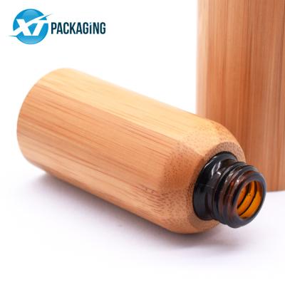 China Cosmetic Packaging Essential Oil Perfume Dropper Bottle Glass Logo Frosted Bamboo Dropper Bottle With Bamboo Cap for sale