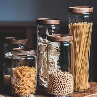 China Hot Selling Transparent Freshness Retention Rotundity Kitchen Seal Glass Storage Jar With Acacia Wood Lid for sale