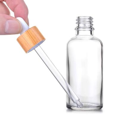 China Personal Care 5ml/10ml/15ml Empty Cosmetic Glass Dropper Bottle With Bamboo Dropper Tamper Cap for sale