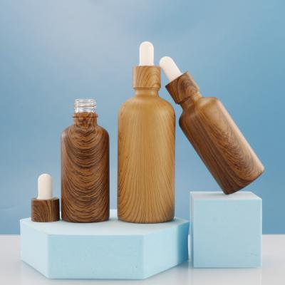 China Hot Selling Personal Care 30ml 50ml Essential Oil Glass Dropper Bottle Frosted Glass Bottle With Bamboo Cap for sale