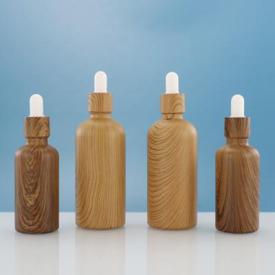 China Essential Oil Cosmetic Bamboo Glass Bottle With Bamboo Dropper Cap For Face Care Serum 30ml Container for sale