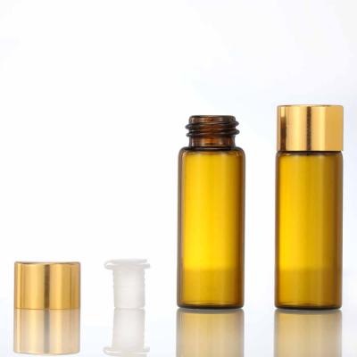 China Cosmetic Packing Amber Screw Bottle Essential Oil Bottles Glass Vials With Gold Cap for sale