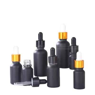 China Matte Black Cosmetic Packing 10ml 30ml 50ml Round Shape Essential Oil Glass Bottle With Cap for sale