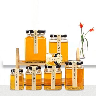 China New Design Clear Empty Jars Four-Sided Food Honey Jar Packaging Glass Bottles With Screw Sealing Lids for sale