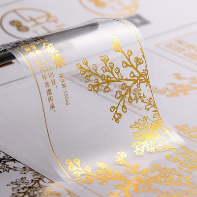 China Waterproof Ignition Clear Bottle Sticker Foil Roll Mounted Transparent Gold Foil Logo Design Aluminum Plastic Sticker Labels for sale