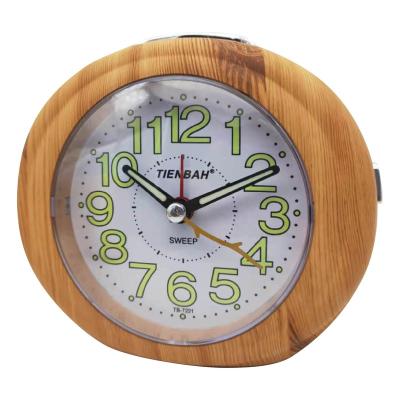 China Wooden Frame Antique Creative Round Bedside Edge Style Melody Table Night Light Silent Analog Alarm Clock for sale