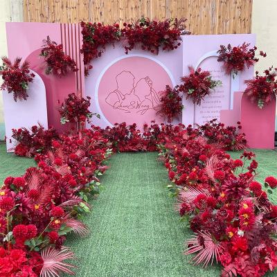 China Flower arrangement simulation floral flowers in wedding ceremony hall chinese red wedding stage background decoration road guide wedding flower row for sale