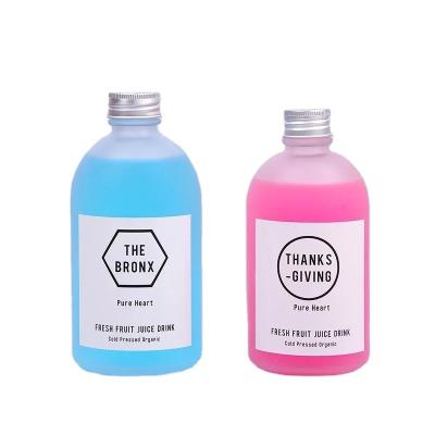 China Beverage 250ml 350ml 500ml Round Glass Beverage Bottle Frosted Soft Drink Juice Glass Bottle With Aluminum Screw Lid for sale