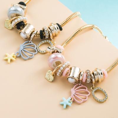 China FASHIONABLE hot sale shell charm bracelet gold plated stainless steel crystal bead bracelet pendant open bangle for women for sale