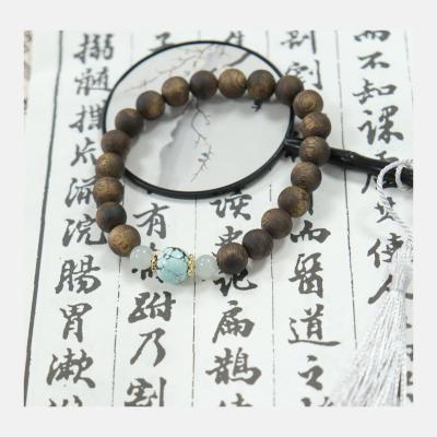 China Brazalete de madera de agar de color turquesa de jade marrón oscuro décimo grado en venta