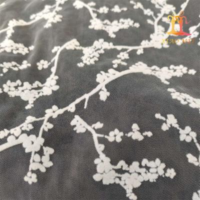 China Fancy Tulle Fabric Viable Elegant White Flocking Decorative Mesh Fabric For Skirt for sale