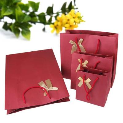 China Recyclable Take Away Merry Xmass Paper Bags With Satin Ribbon Gift Bag Shopping Gift Paper Bag With Handle for sale