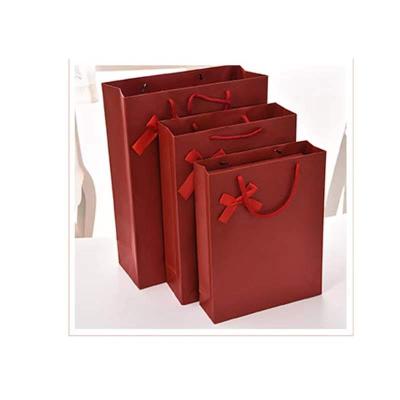 China Recyclable Customized Design Golden Logo Jewelry Perfume Bag Cupcake Shoe Packaging Paper Bag With Bow Knot for sale