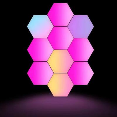 China DIY Modern Creative Hexagon Light Panels LED Wall Mounted Game Lights RGB Modular Night Lights Music Sync with RF Remote Control for sale