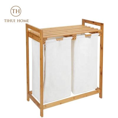 China Tihui Sustainable Home Double 2 Section Bamboo Freestanding Laundry Hamper Organizer With Removable Storage Sorter Bags for sale