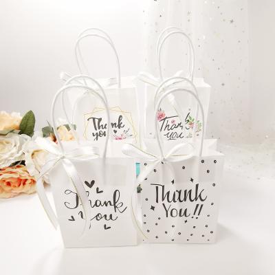 China Stunning Mini Thank You Kraft Handle Recyclable Gift Bag Small Size Paper Gift Packaging Wrapping Paper Bag With Ribbon for sale