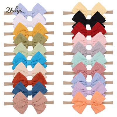 China Super soft nylon hair accessories 2384 candy color headband girls bowknot infant baby hair band for sale