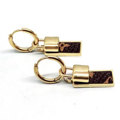 China Ethnic Stainless Steel Engrave Letter Gold Plated Word Leather Stud Earrring for sale