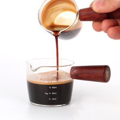 China Viable Heat Resistant Glass Measuring Cup Espresso Coffee Milk Ounce Glass Mug With Wooden Handle Espresso Wooden Measuring Cup for sale