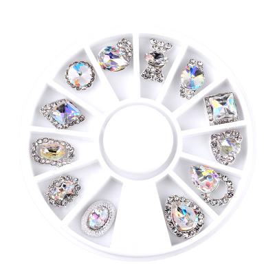 China 12pcs/Box 12pcs/Box Luxury Clear Alloy Rhinestone Nail Stone 3D Luxury Clear Wheel ab Mix Waterdrop Arc-knot Designs Metal Decorations Manicure Tools for sale