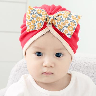 China Comfotable autumn and winter baby daisy bow tire hat newborn cotton thickened senior hat male and female baby halogen hat for sale