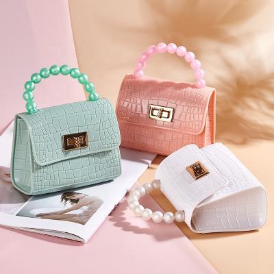 China New fashion fashion design candy color mini bag pearl square handbag lady shoulder chain jelly bag for sale