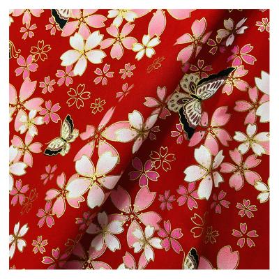 China New Organic Stain Safflower Butterfly Print Cotton New Year Garment Tan Fabric for sale