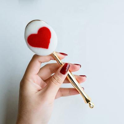 China Angular Blush Three-Dimensional Gold Heart Tassel Long Handle Simple Pattern OEM Bling Makeup Brush for sale