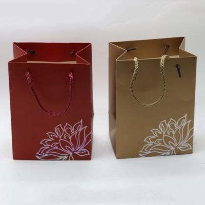 China Wholesale custom made red high quality cheap paper bag recyclable LOGO badge paper bag packaging paper or gold for sale