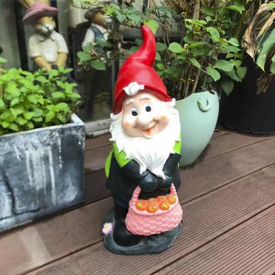 China Magnesium Factory Polyresin World Gnome With A Basket Outdoor Resin Craft Garden Gnomes Statue for sale