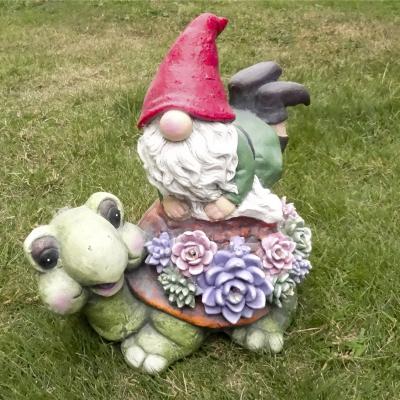 China Cute Outdoor Statue World Gnome Garden Plant Gnome Statue Large Sculptures With Solar Lights Resin Gnome Figurine Sitting On Turtle for sale