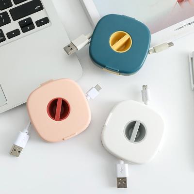 China Viable Newcomers Fit Multifunctional Rotatable Earphone Wire Data Cable Storage Box With Mobile Phone Holder for sale