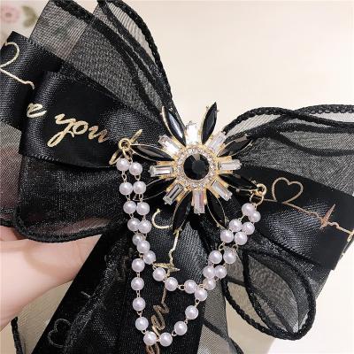 China Fashionable Exaggerated CZ Layered Pearl Tassel Mesh Lace Ribbon Bowknot Brooch Tie Girls Fairy Brooch With Pin Hair Bow Safe Brooch for sale