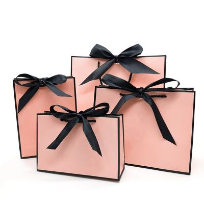 China Pretty Recyclable Pink Kraft Gift Bag Gold Present Box For Pajamas Clothes Books Packaging Gold Handle Paper Box Bags Kraft Paper Gift Bag for sale