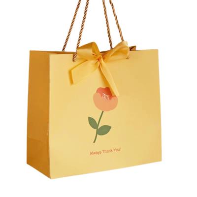 China Recycled Materials Custom Printed Wedding Party Gift Packaging Carrier Luxury Reusable Paper Small Paper Bag With Bow for sale