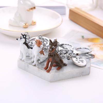 China Durable Creative Cute White Stereo Dog Zinc Alloy Commemorative Unisex Key Chain for sale